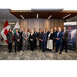 Maple Disruption 2025 VIP visitors pose for a group photo.